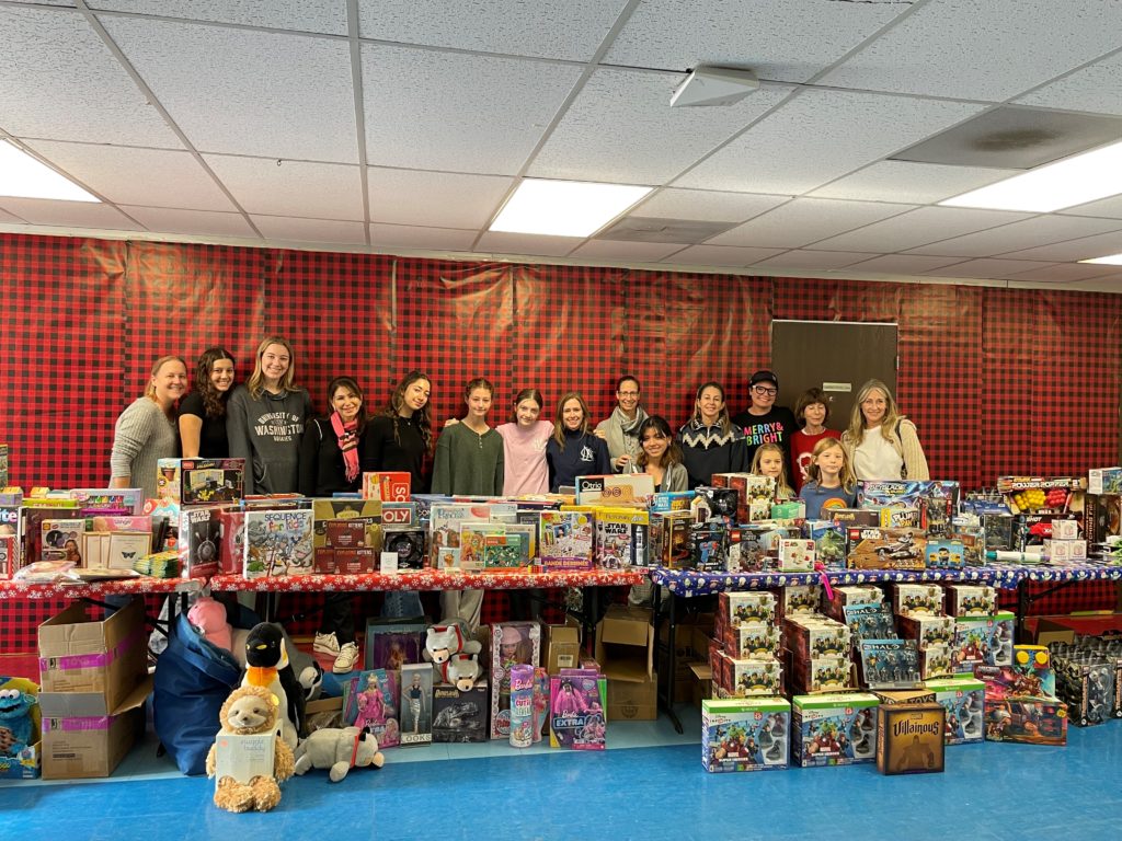 a group of people standing behind a table with boxes on it