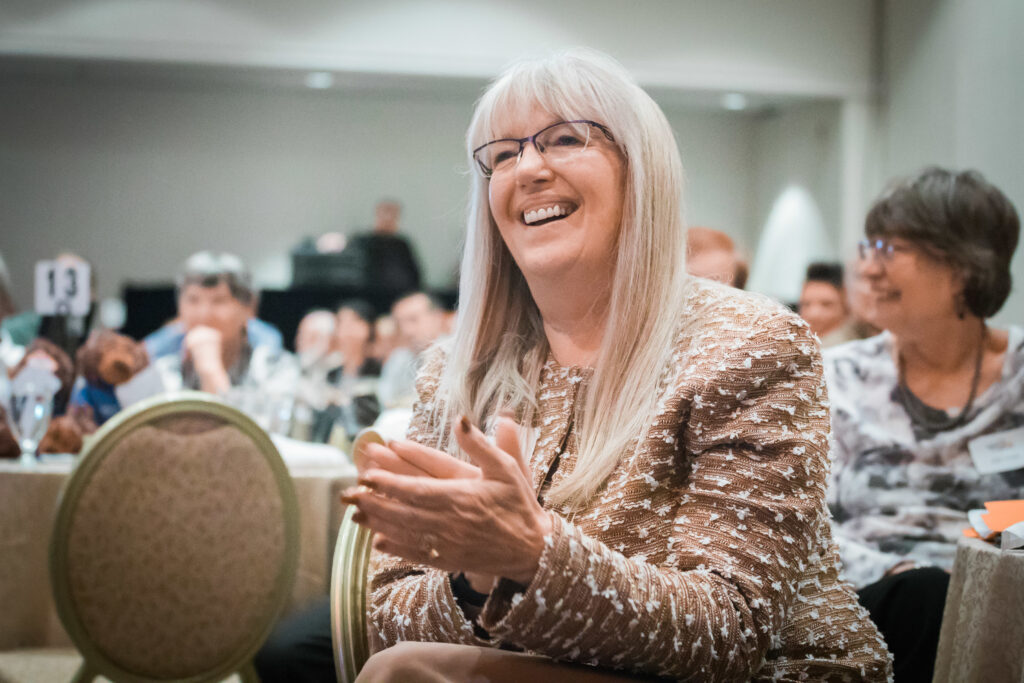 a woman smiling and clapping