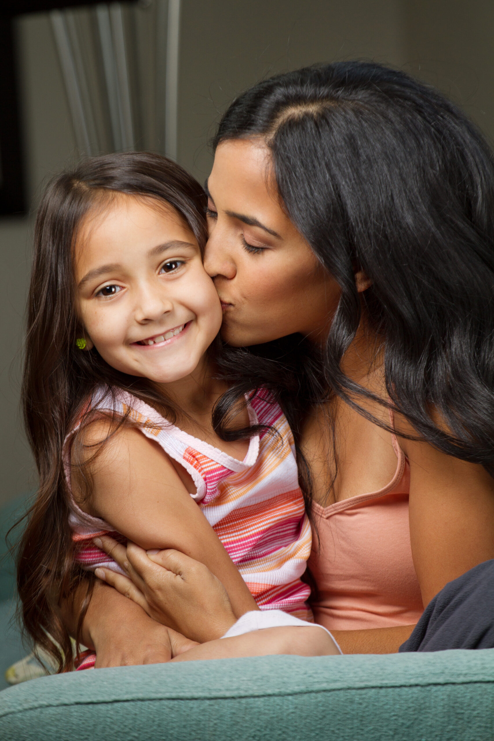 Hispanic Mom Kissing Her Daughter