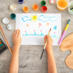 Little girl painting at table