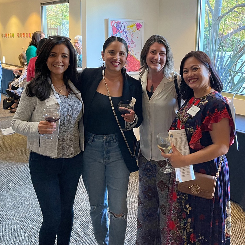 a group of women holding wine glasses