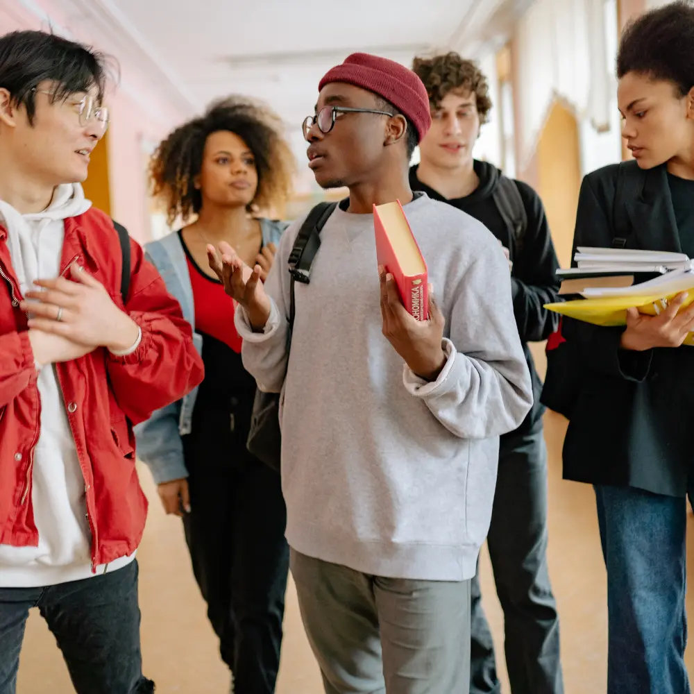 peer services for unhoused - teens talking in a hallway