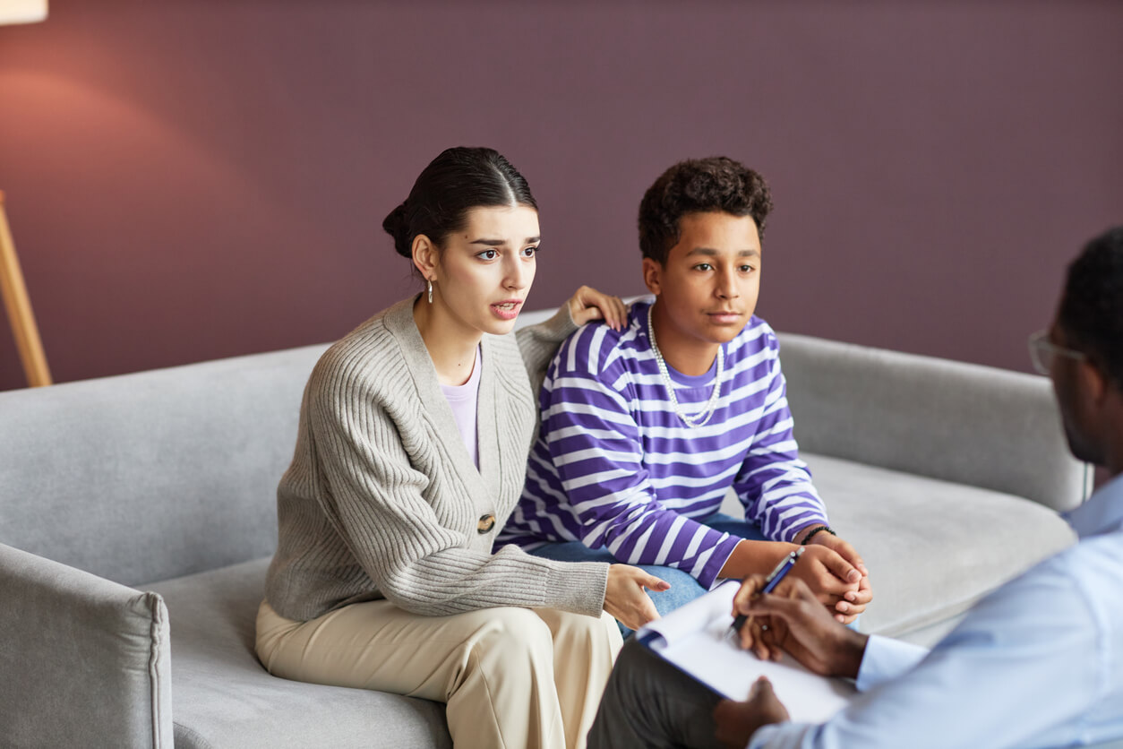 Health professional assisting a kid in counseling