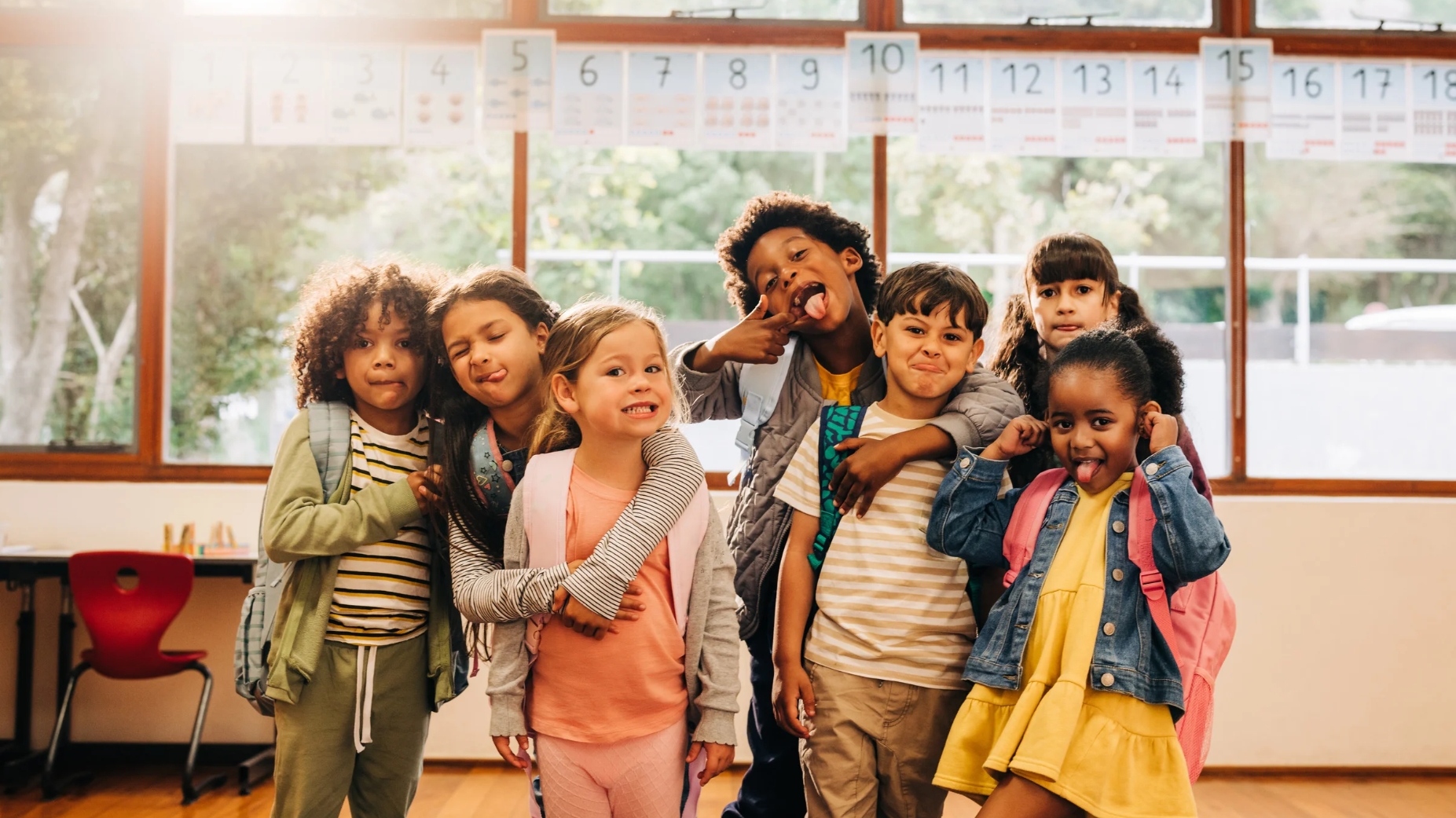 A group of school children pose for a photo making funny faces