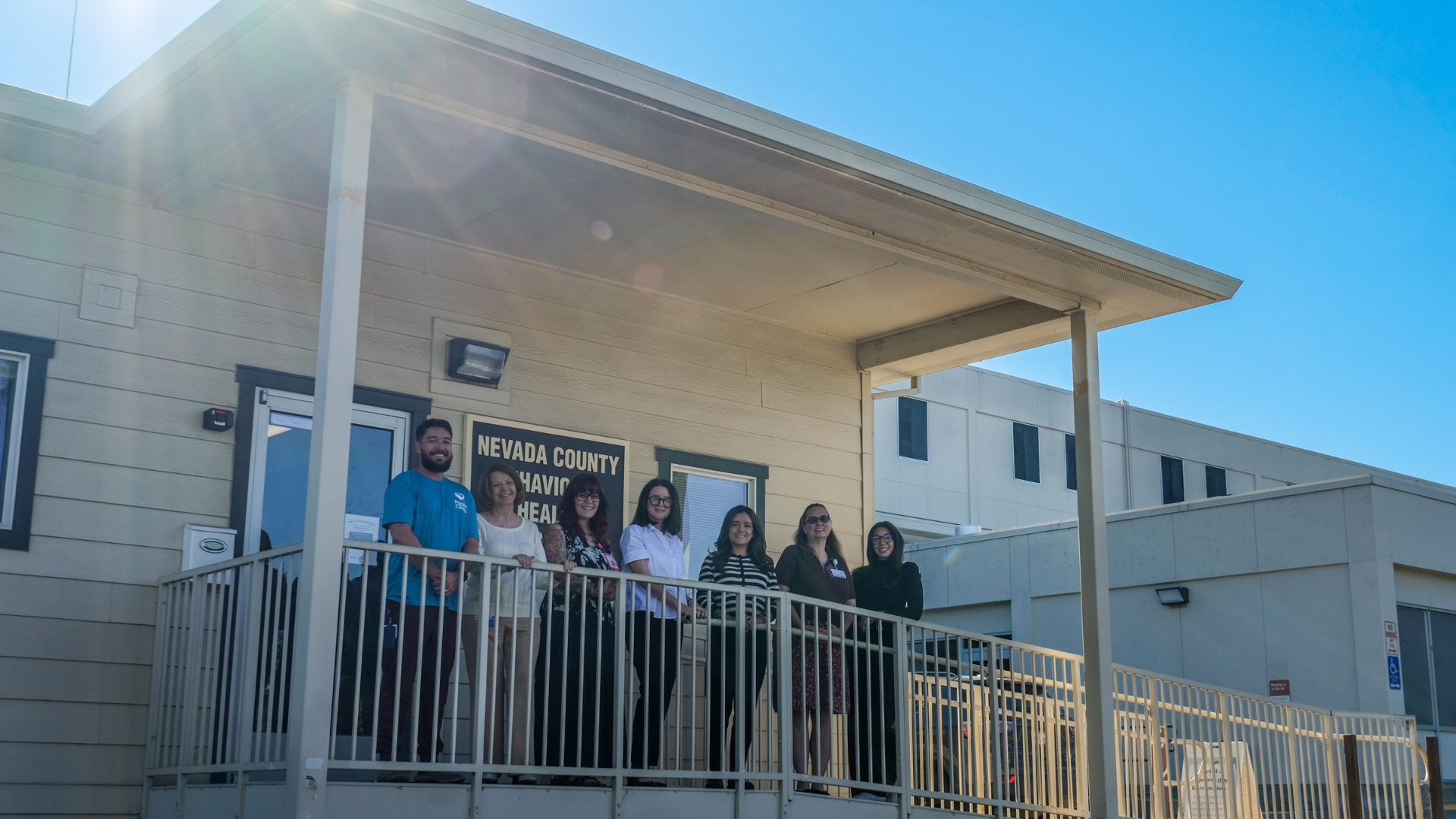 Staff pose in front of the CSU office